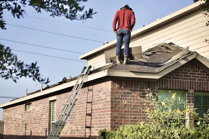 Professional roofer working on a residential roof in Lake of the Pines